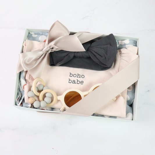 Baby clothing and accessories set with 'boho babe' text in a box on a white background