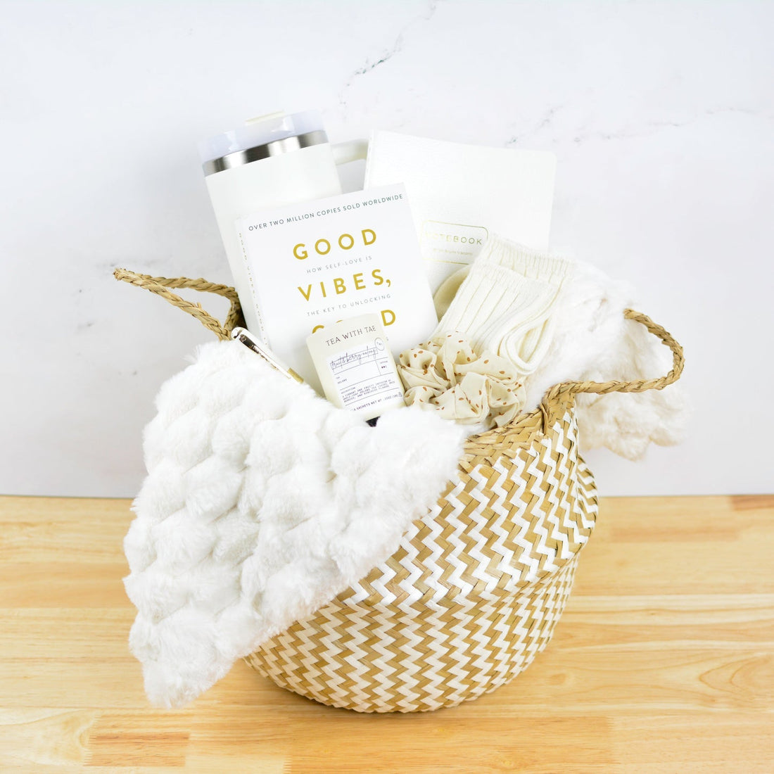 Curated luxe wellness gift basket with an insulated tumbler, notebook, plush throw, and self-care comforts for client appreci