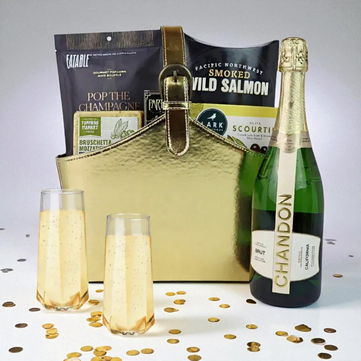 Luxury gold gift basket with Chandon Brut sparkling wine, Pacific Northwest smoked salmon, popcorn, and gourmet snacks — elegant gift option.