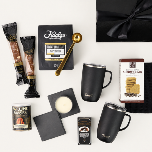 Collection of coffee-themed items including coffee packets, mugs, and a black box on a white background