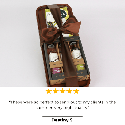 Gift set with olive oil bottles and a bow on a light gray background, featuring a 5-star rating and review from Destiny S.