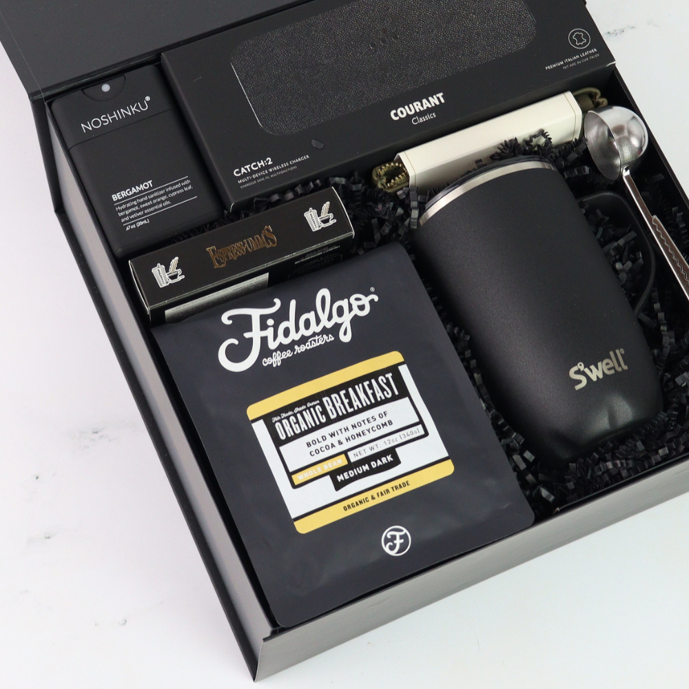 Gift set with Fidalgo coffee package, black mug, and other items in a box.