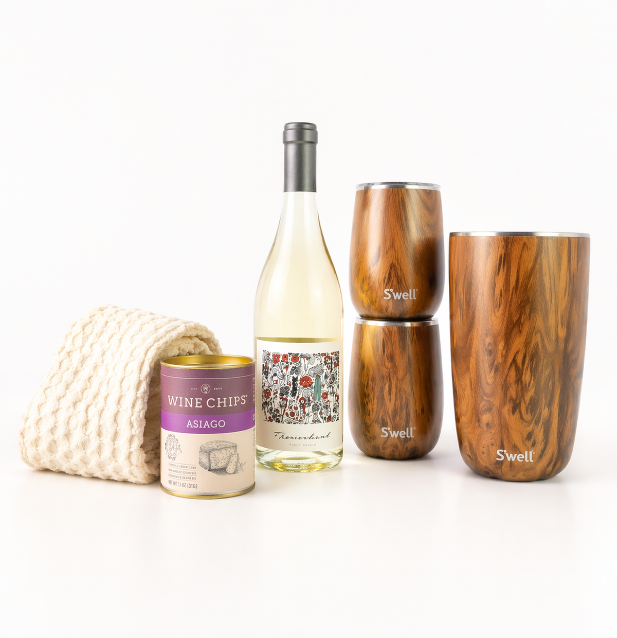 Wine bottle, can of wine chips, and two wooden tumblers on a white background