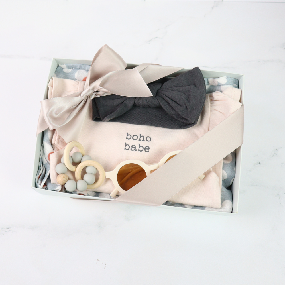 Baby clothing and accessories set with 'boho babe' text in a box on a white background
